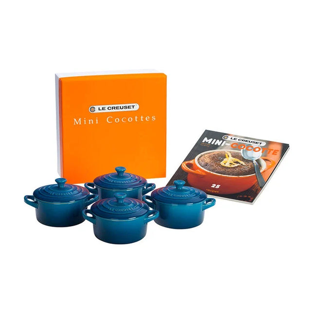 a set of four blue crockery items, including four small blue pots or casserole dishes, along with a box and a cookbook.